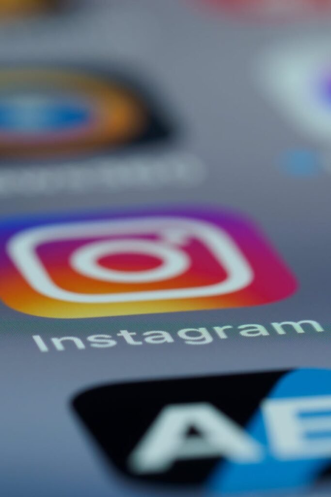 Instagram app icon in focus on a smartphone screen, blurred background.