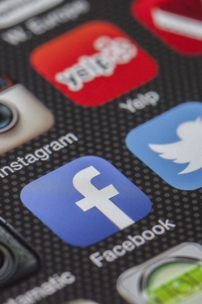 Close-up image of various social media app icons on a smartphone screen.